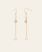 The CAMELLIA Audrey Opal Pearl Earrings feature a gold dangle design with pearl accents, opal details, hook clasps, and a delicate chain. Sterling silver touches add elegance.
