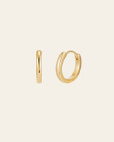 The 15mm Mother Hoops by CAMELLIA, crafted from hypoallergenic 14K yellow gold vermeil, are shown against a plain backdrop. Displayed in both side and front views, these small gold hoop earrings embody elegance and purity with their minimalist design.