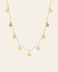 The CAMELLIA Mother Chain Necklace is crafted in 14K yellow gold vermeil, showcasing round disc pendants elegantly dangling from a delicate chain.