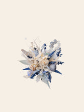 A decorative arrangement of blue and beige elements, with dried flowers, seashells, and foliage on a light background, evokes the handcrafted Ocean Flower Ring by CAMELLIA from New York.