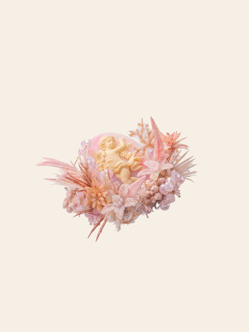 The Cherry Blossom Birth Flower Ring by CAMELLIA, handcrafted in New York, features a pastel flower and pink foliage design with a central yellow accent, set against a light background with coral-like elements. The Cherry Blossom Birth Flower Ring by CAMELLIA, handcrafted in New York, features a pastel flower and pink foliage design with a central yellow accent, set against a light background with coral-like elements.