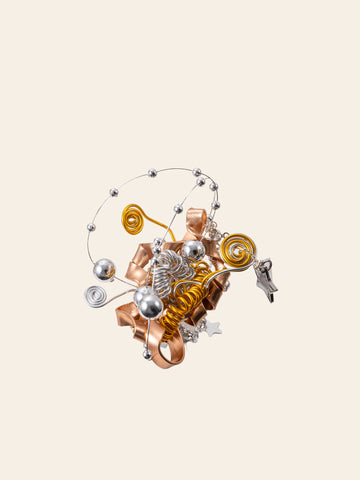 The Star Flower Ring by CAMELLIA features an abstract sculptural design with metallic spirals, coils, and spheres in gold, silver, and copper tones adorned with star-shaped charms against a light background, reminiscent of handcrafted jewelry. The Star Flower Ring by CAMELLIA features an abstract sculptural design with metallic spirals, coils, and spheres in gold, silver, and copper tones adorned with star-shaped charms against a light background, reminiscent of handcrafted jewelry.