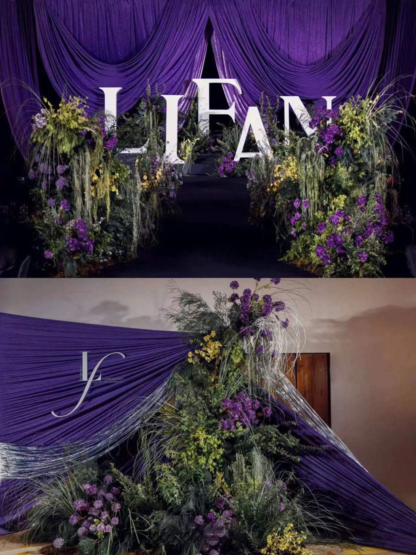 Two floral installations with purple drapery and greenery surround white "LIFAN" letters. The top is dense with flowers, the bottom has fewer blooms, and CAMELLIA's Dreamy Purple Green Wedding Flower Rings add a handcrafted touch to the romantic scene.