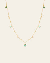The CAMELLIA Moren Emerald Diamond Necklace showcases small diamond accents and spaced emerald pendants set in 14K Yellow Gold Vermeil.