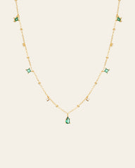 The CAMELLIA Moren Emerald Diamond Necklace showcases small diamond accents and spaced emerald pendants set in 14K Yellow Gold Vermeil.