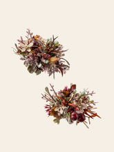 Two CAMELLIA Medieval Gothic Wedding Flower Rings showcase decorative floral arrangements with colorful leaves, flowers, and small berries on a plain background, echoing handcrafted beauty.