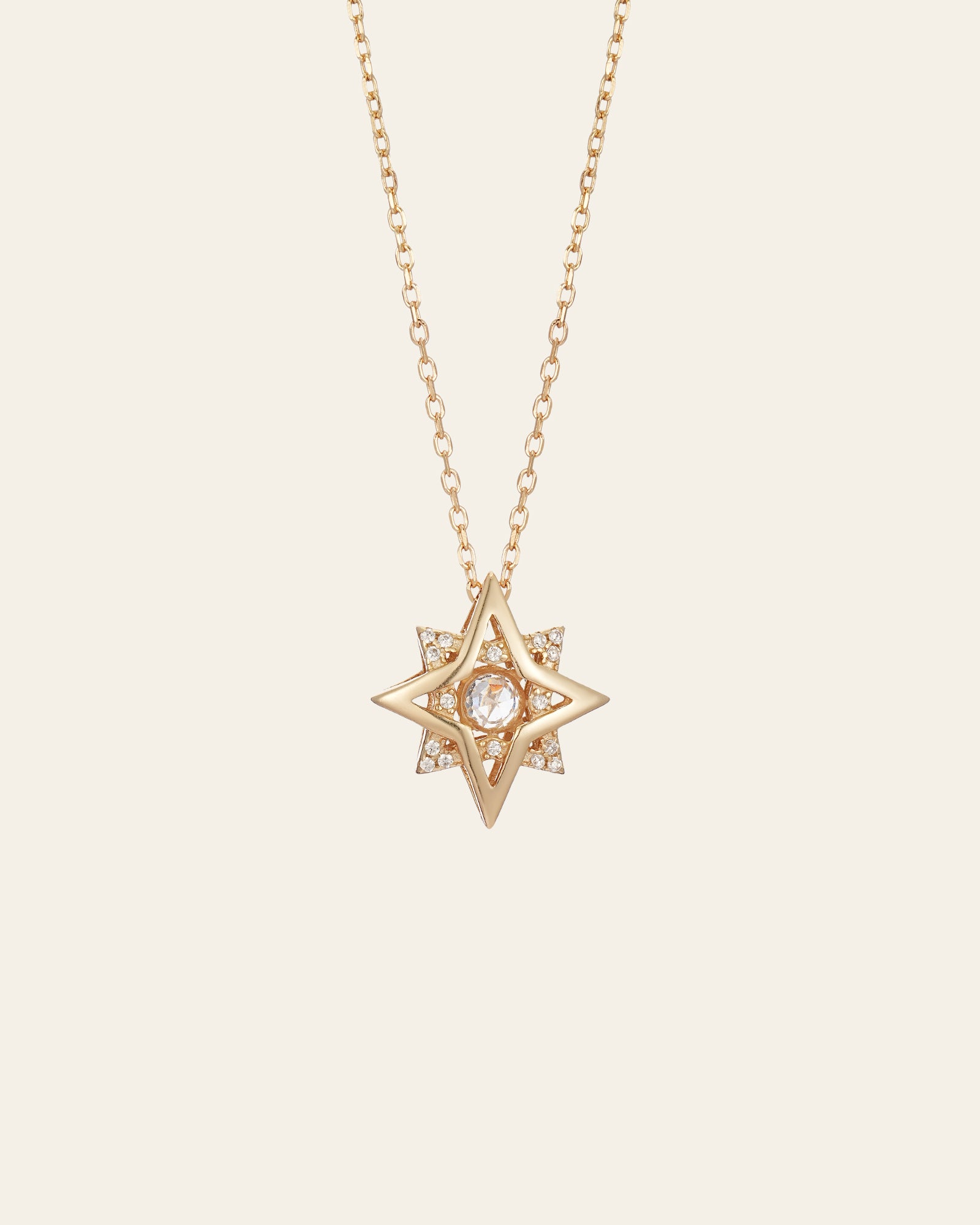 The New York Diamond Pentagram Necklace by CAMELLIA features a stunning gold star-shaped pendant crafted in 14K yellow gold vermeil with a dazzling diamond center on a delicate chain set against a plain background.