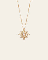 The New York Diamond Pentagram Necklace by CAMELLIA features a stunning gold star-shaped pendant crafted in 14K yellow gold vermeil with a dazzling diamond center on a delicate chain set against a plain background.