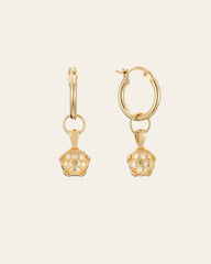 The Elsa Poppy Peridot Earrings by CAMELLIA, crafted in hypoallergenic 14K Yellow Gold Vermeil, feature gold hoops with flower-shaped pendants and are showcased against a cream background.