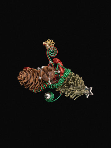 The Christmas Flower Ring by CAMELLIA is a decorative holiday piece with pinecones, green and red coiled wires, small bells, dried preserved flowers, and a metallic star against a black background. The Christmas Flower Ring by CAMELLIA is a decorative holiday piece with pinecones, green and red coiled wires, small bells, dried preserved flowers, and a metallic star against a black background.
