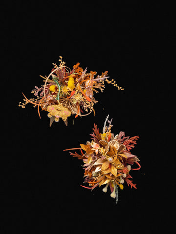 Two intricate, colorful floral arrangements featuring dried flowers and foliage on a black background, akin to Fortune New Chinese Wedding Flower Rings handcrafted by CAMELLIA in New York. Two intricate, colorful floral arrangements featuring dried flowers and foliage on a black background, akin to Fortune New Chinese Wedding Flower Rings handcrafted by CAMELLIA in New York.