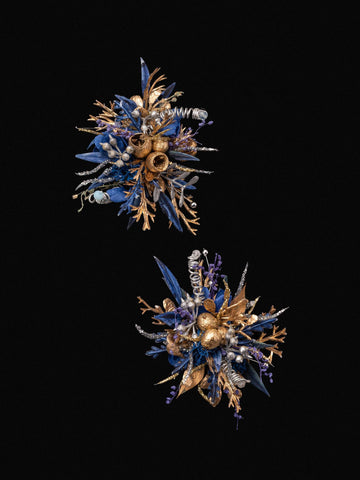 The Blue and Gold Baroque Castle Wedding Flower Rings by CAMELLIA display intricate floral arrangements with metallic textures and diverse plant shapes, set against a black background, embodying the elegance of preserved flowers. The Blue and Gold Baroque Castle Wedding Flower Rings by CAMELLIA display intricate floral arrangements with metallic textures and diverse plant shapes, set against a black background, embodying the elegance of preserved flowers.