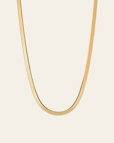 The 3.5 mm Snake Chain Necklace by CAMELLIA, made of 14K yellow gold vermeil, is elegantly showcased against a simple light background.