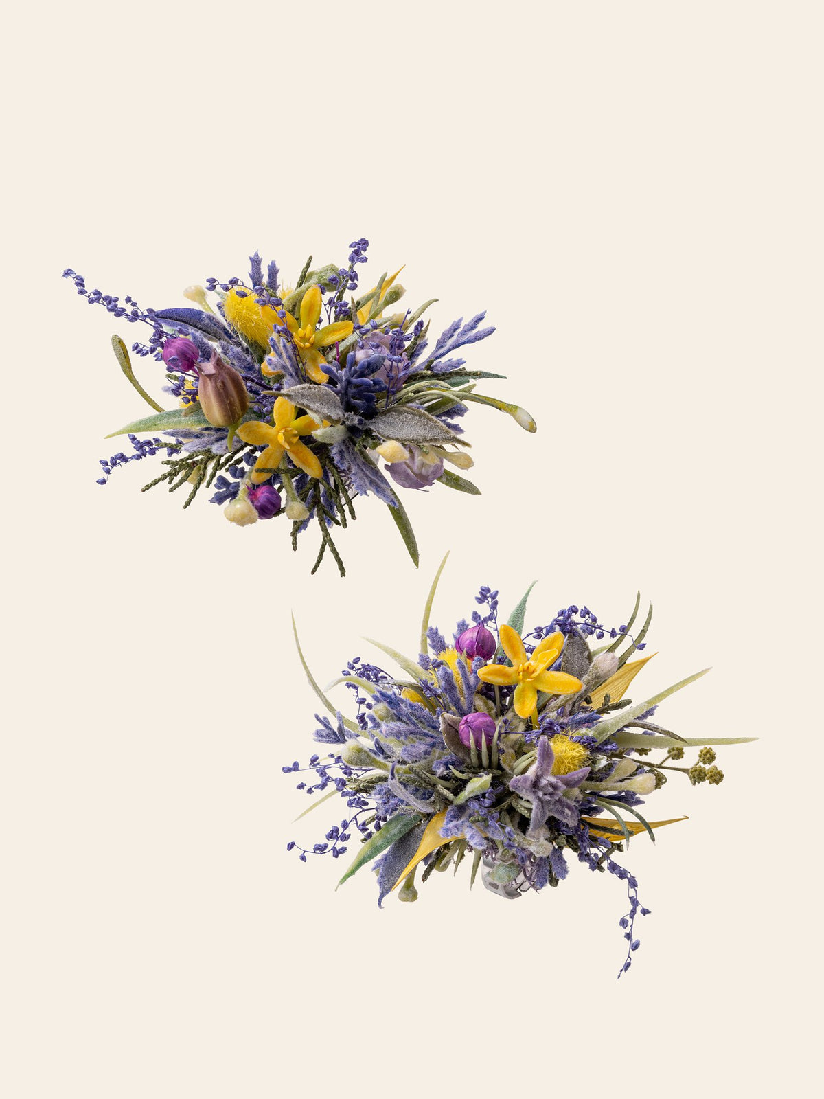 Two Dreamy Purple Green Wedding Flower Rings by CAMELLIA, featuring handcrafted bouquets with a mix of purple, yellow, and green flowers and foliage on a plain light background.