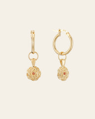 The Elsa Carnation Garnet Earrings by CAMELLIA are gold hoop earrings featuring floral pendants and central gems, handcrafted in New York.