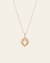 The CAMELLIA Capri Moonstone Necklace showcases an oval white moonstone pendant at its center, enhanced by intricate 14K yellow gold vermeil detailing on a gold chain.
