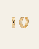 The CAMELLIA Starburst Cz Hoops are 14K Yellow Gold Vermeil earrings with star engravings on a plain background, crafted on a sterling silver base. They're hypoallergenic for comfort.