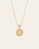 The Elsa Daisy Diamond Necklace by CAMELLIA features a delicate 14K Yellow Gold Vermeil chain and a round pendant with a central diamond-like gem. Handcrafted in New York, it's an elegant piece that adds timeless charm to any outfit.