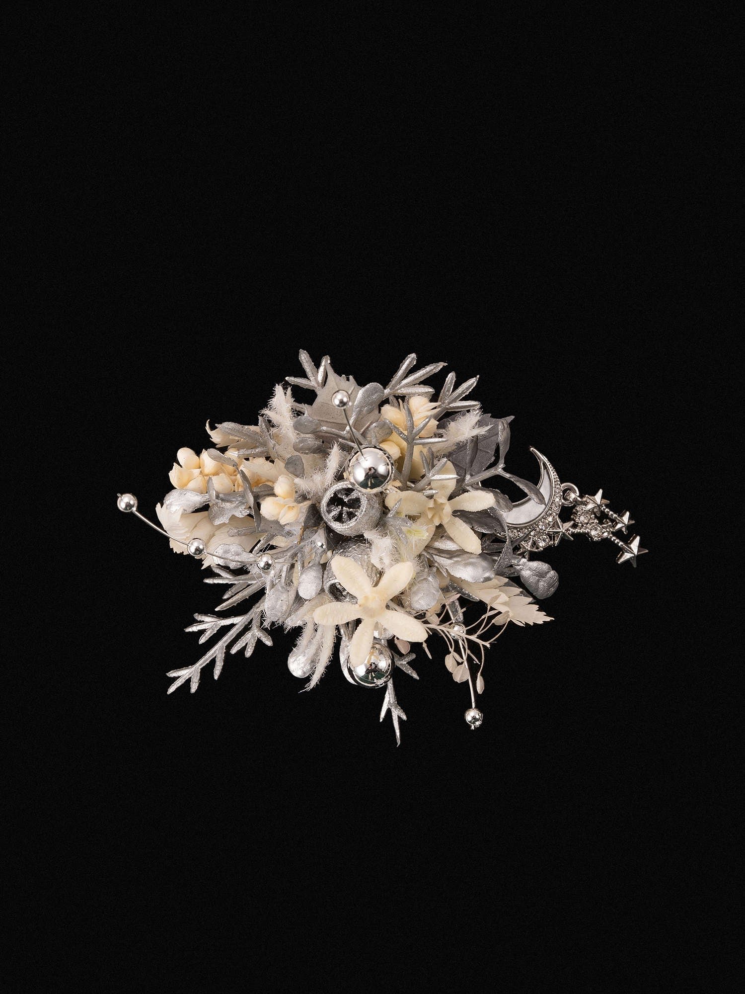 The CAMELLIA Moon Flower Ring features a bouquet of dried preserved flowers and plants with metallic accents, intricately arranged against a black background, creating the perfect custom symbol flower ring.