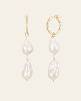 The Elysia Pearl Earrings by CAMELLIA feature gold hoops, each adorned with two uniquely shaped white pearls in exquisite 14K Yellow Gold Vermeil.