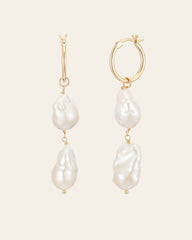 The Elysia Pearl Earrings by CAMELLIA feature gold hoops, each adorned with two uniquely shaped white pearls in exquisite 14K Yellow Gold Vermeil.