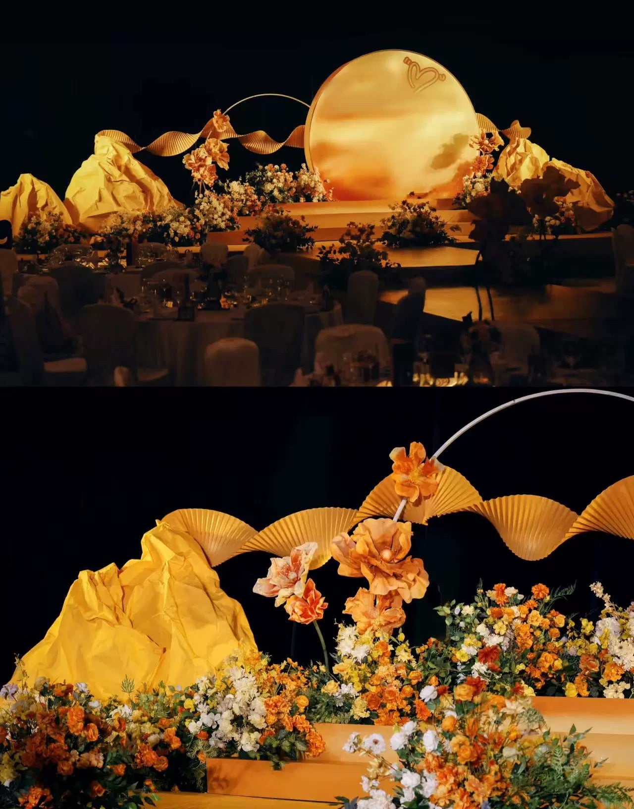 Elegant stage setup with a large golden disk backdrop, yellow drapes, and orange floral arrangements featuring CAMELLIA's Love In The Sunset Wind Wedding Flower Rings made from dried flowers.