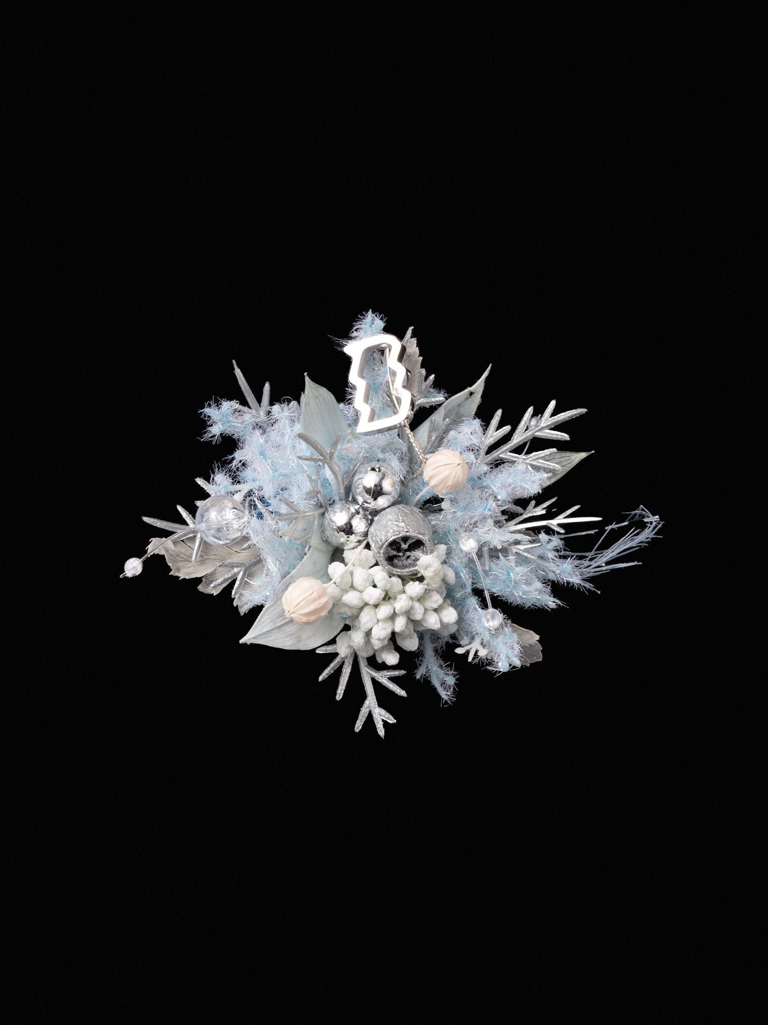The Aquarius Flower Ring by CAMELLIA features a decorative silver and blue design with leaves, white berries, fluffy textures, and silver baubles on a black background, reminiscent of a handcrafted New York treasure.