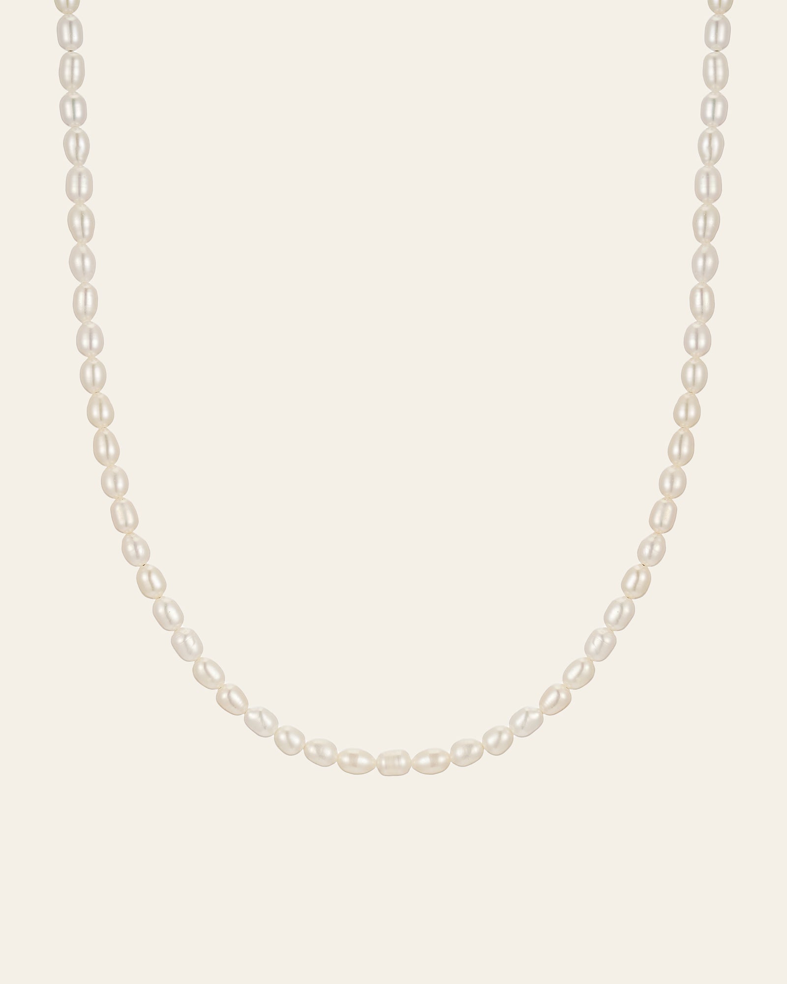 The CAMELLIA Baroque Pearl Necklace features a single strand of white pearls highlighted by a sterling silver clasp for an elegant touch.