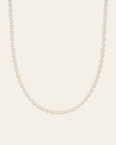 The CAMELLIA Baroque Pearl Necklace features a single strand of white pearls highlighted by a sterling silver clasp for an elegant touch.