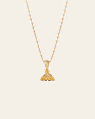 The Elsa Violet Amethyst Necklace by CAMELLIA is a handcrafted gold pendant necklace with intricate designs and small gemstones, elegantly suspended on a fine chain, set against a plain background.