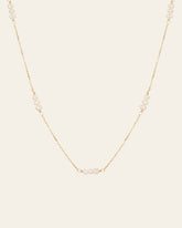 The CAMELLIA Polly Pearl Chain Necklace is a hypoallergenic piece crafted in 14K Yellow Gold Vermeil, showcasing small pearls evenly spaced along its delicate design.