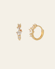 CAMELLIA's Quillie Cz Hoops feature hypoallergenic gold vermeil hoop earrings adorned with varied shaped gemstones, including square and rectangular cuts, set on the front for a luxurious touch, ensuring comfort and style all day.