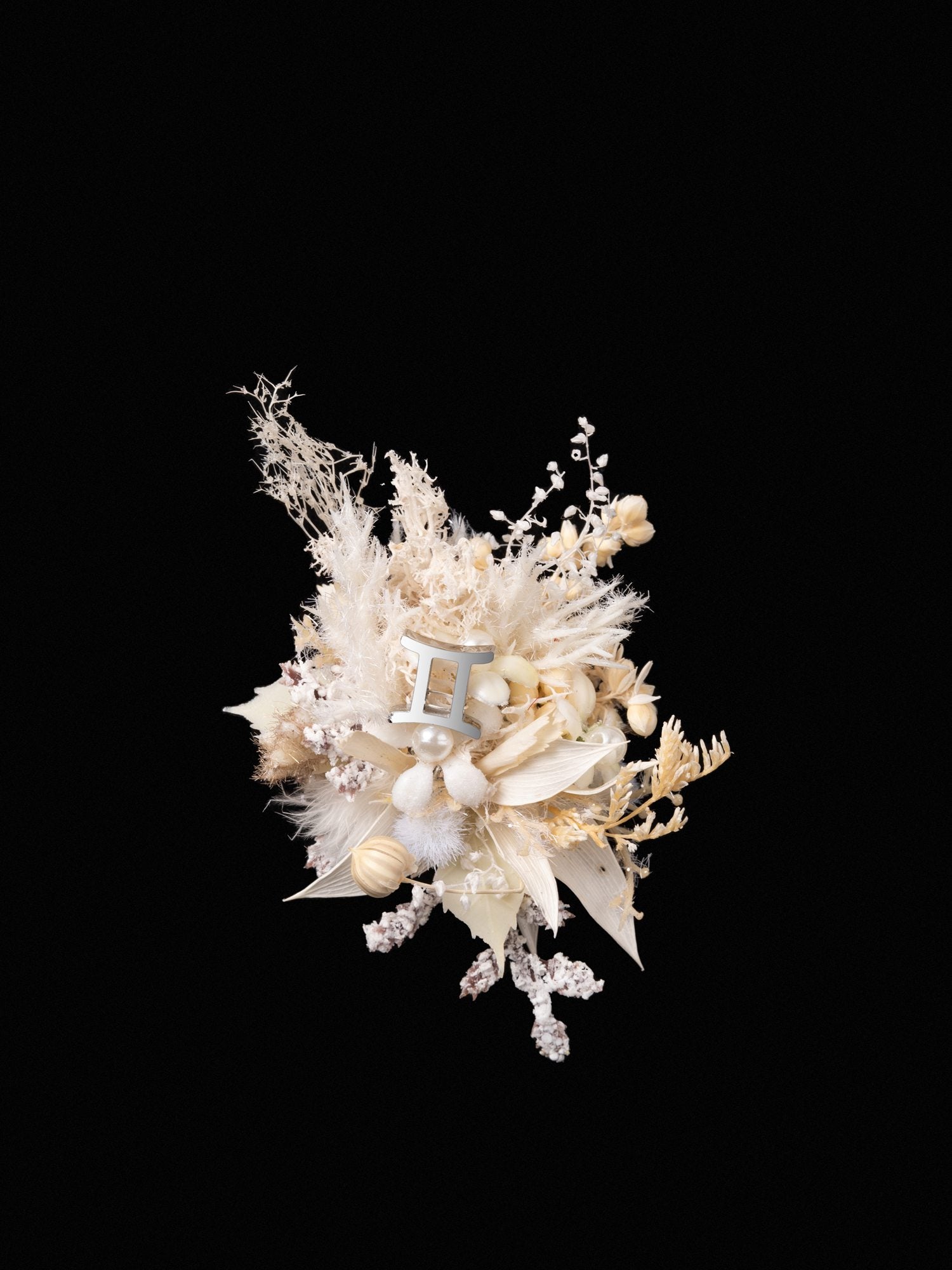 A bouquet of dried white and beige flowers with diverse blooms and grasses evokes the elegance of CAMELLIA's Gemini Flower Ring, reminiscent of a handcrafted New York piece, displayed against a black background.