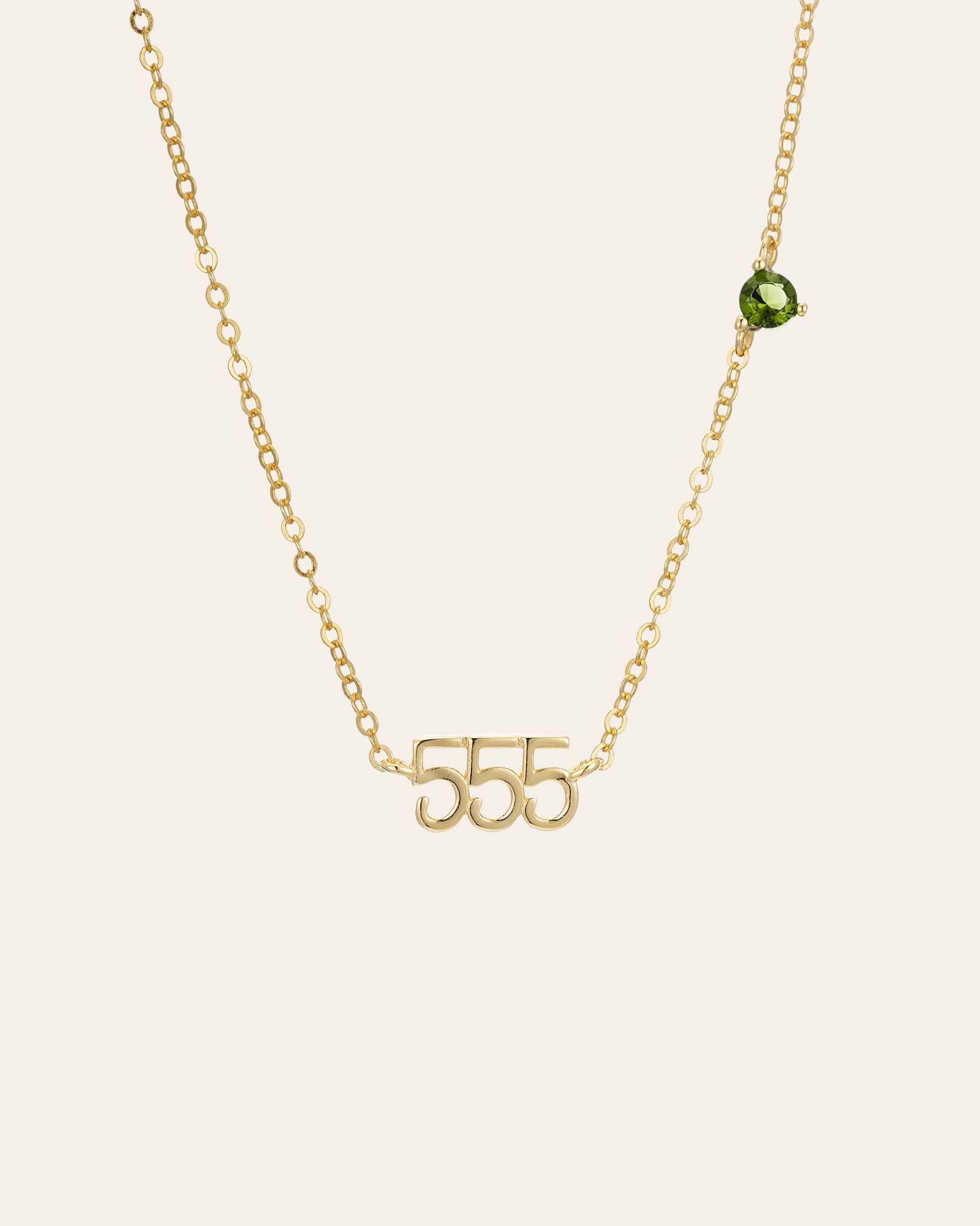 The CAMELLIA 555 Angel Number Choker with Peridot is a 14K gold vermeil necklace featuring an off-center peridot gemstone, shown against a plain background.