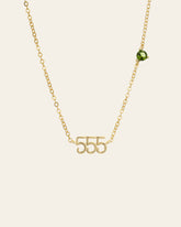 The CAMELLIA 555 Angel Number Choker with Peridot is a 14K gold vermeil necklace featuring an off-center peridot gemstone, shown against a plain background.