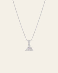 The CAMELLIA Elsa Violet Amethyst Necklace showcases a handcrafted silver design with a thin chain and a pendant featuring clear stones arranged in an elegant floral shape.