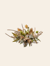 The Taurus Flower Ring by CAMELLIA features a handcrafted design with vibrant yellow flowers, lush green leaves, and gold accents against a light backdrop.