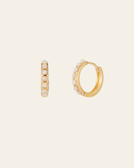 The CAMELLIA Una Opal Hoops are crafted in 14K Yellow Gold Vermeil, featuring white pearls in a line on the outer side, and displayed on a plain light background.