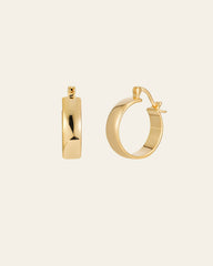 The CAMELLIA Eťa Hoops, minimalist jewelry pieces, are set against a plain background. One earring displays its elegant front view, while the other shows its graceful side profile.