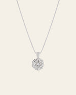 The Elsa Rose Pearl Necklace by CAMELLIA features a sterling silver pendant shaped like a rose, gracefully hanging from a fine chain against a light background. Handcrafted in New York, it embodies timeless charm.
