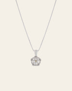 The CAMELLIA Elsa Poppy Peridot Necklace is a stunning sterling silver piece with a flower-shaped pendant featuring five petals and a delicate center. Hypoallergenic for sensitive skin, it radiates elegance and comfort.