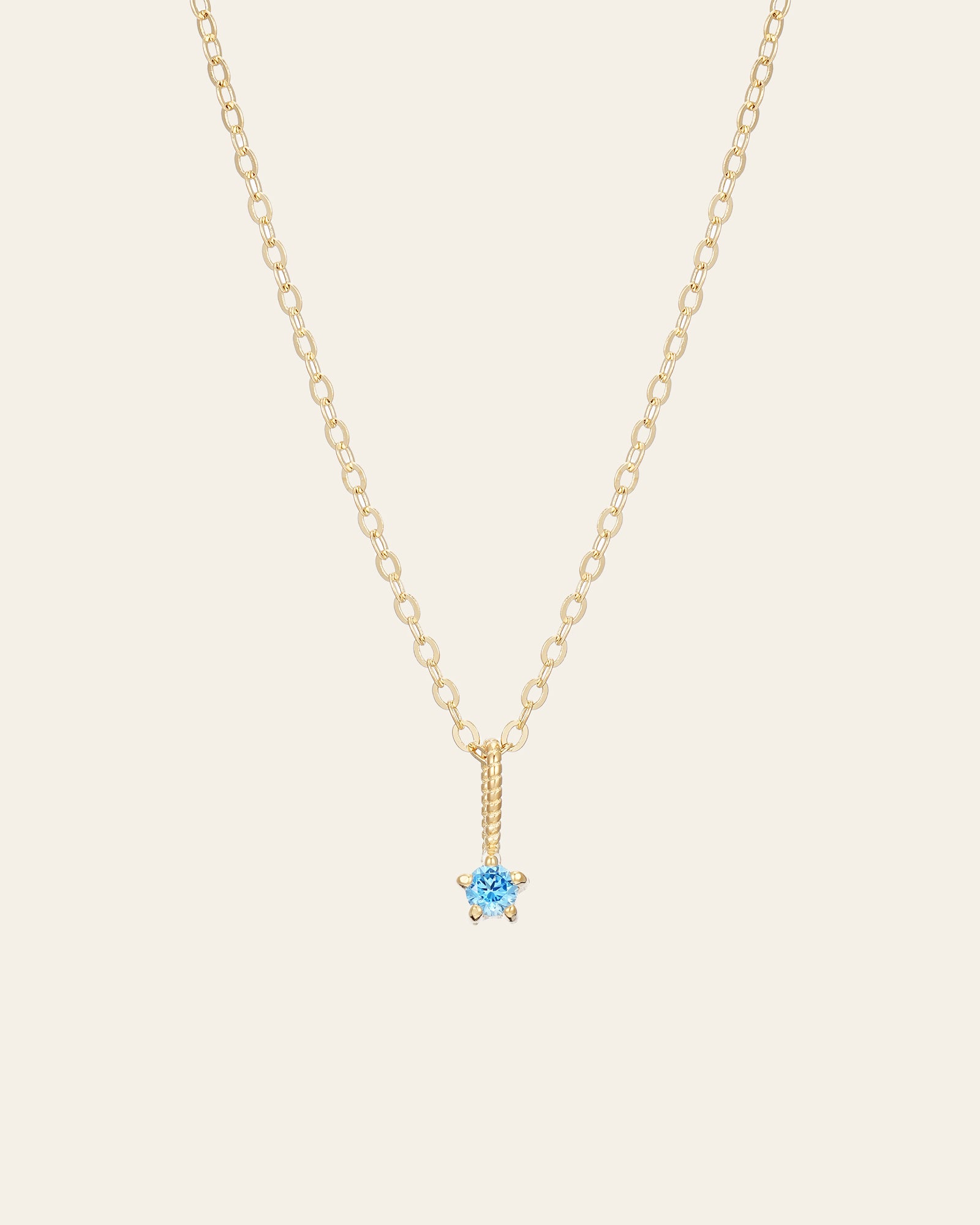 The Petite Birthstone Necklace by CAMELLIA is a stunning 14K Yellow Gold Vermeil chain with a small blue gemstone pendant for a luxurious finish.