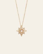 The New York Diamond Pentagram Necklace by CAMELLIA features a stunning gold star-shaped pendant crafted in 14K yellow gold vermeil with a dazzling diamond center on a delicate chain set against a plain background.