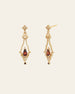 The Sophina Garnet Earrings by CAMELLIA feature gold ornate diamond-shaped tops with garnet teardrop gemstones, crafted in 14K Yellow Gold Vermeil against a plain background.