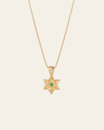 The CAMELLIA Elsa Lily Emerald Necklace, handcrafted in New York, features a star-shaped pendant with an emerald gemstone set in 14K Yellow Gold Vermeil.