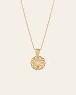 The Elsa Daisy Diamond Necklace by CAMELLIA features a delicate 14K Yellow Gold Vermeil chain and a round pendant with a central diamond-like gem. Handcrafted in New York, it's an elegant piece that adds timeless charm to any outfit.