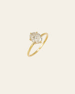 The All of Me Band by CAMELLIA is a gorgeous gold ring with an oval diamond set on a light background, crafted from hypoallergenic materials for optimal comfort.