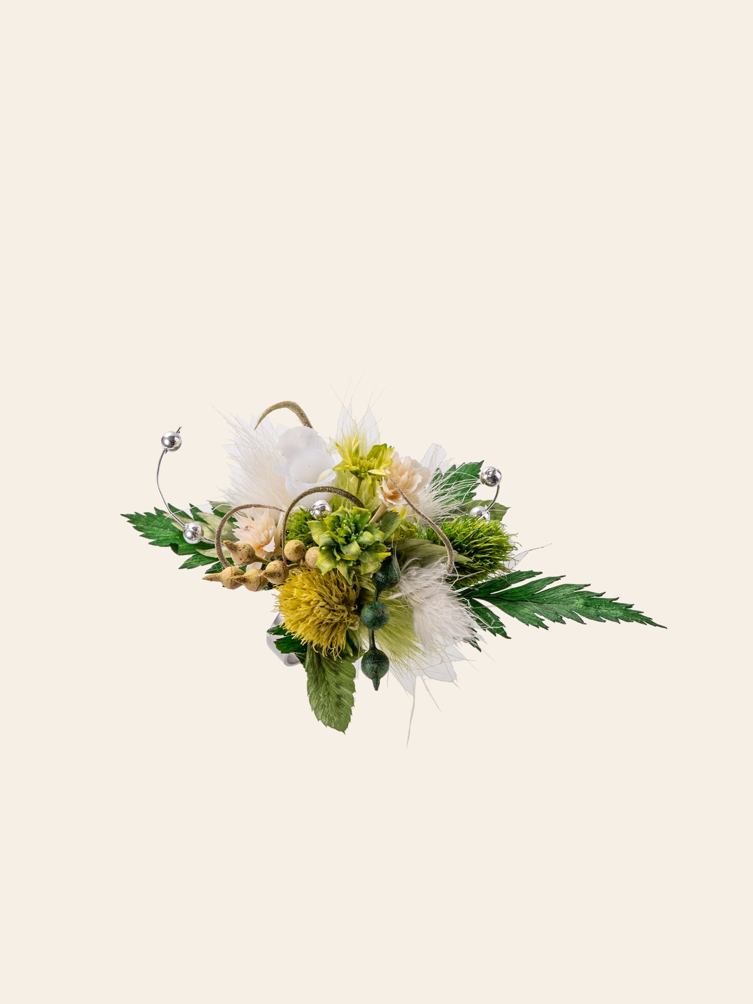 The CAMELLIA Verdant Dreams Flower Ring is a handcrafted bouquet with yellow, white, and green flowers adorned with leaves and decorative silver wires set against a plain light background.