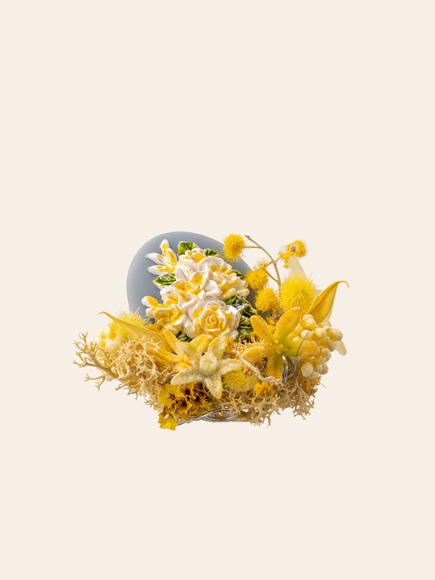 The Freesia Birth Flower Ring by CAMELLIA features a decorative arrangement with yellow and white flowers, including lilies and roses on a light beige backdrop, accented by timeless dried preserved flowers.