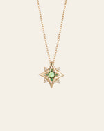The CAMELLIA New York Emerald Pentagram Necklace is a stunning gold star-shaped pendant on a thin chain, featuring a central emerald-like gem surrounded by tiny diamonds, crafted in luxurious 14K Yellow Gold Vermeil.
